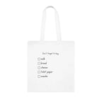 White tote bag with 'Don't forget to buy' checklist: milk, bread, cheese, toilet paper, snacks.