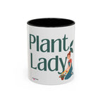 White coffee mug with dark interior, large green “Plant Lady” text and plants