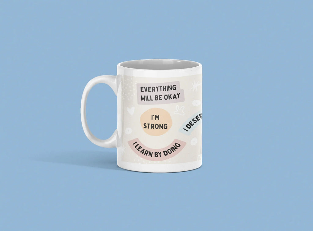 White ceramic mug with 'Everything will be okay' and 'I'm strong' printed design