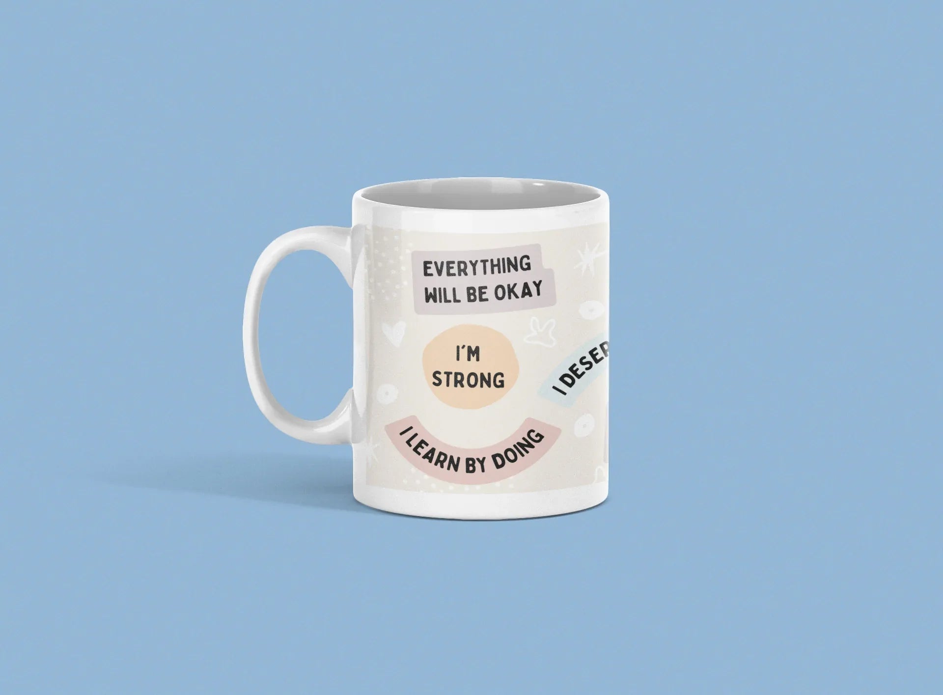 White ceramic mug with 'Everything will be okay' and 'I'm strong' printed design