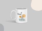 White ceramic mug with Evie name and floral swirl design on front, side angle.
