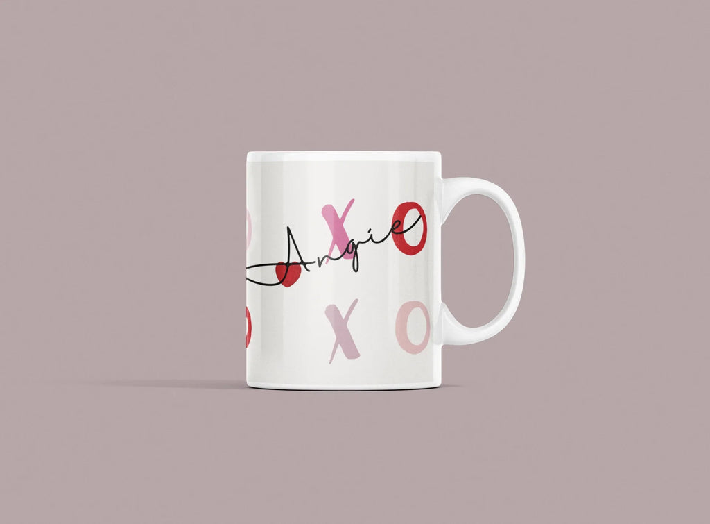 White ceramic mug with custom name “Annie” and XO heart accents in red