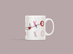White ceramic mug with custom name “Annie” and XO heart accents in red