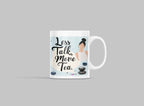 White tea mug on light gray surface with 'Less Talk, More Tea' print
