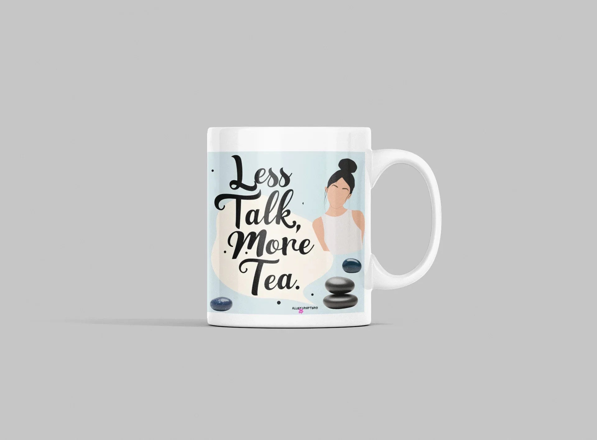 White tea mug on light gray surface with 'Less Talk, More Tea' print