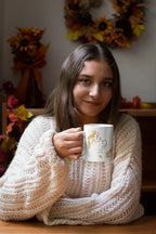 White mug with gold filigree and dark red monogram 'B & J' design