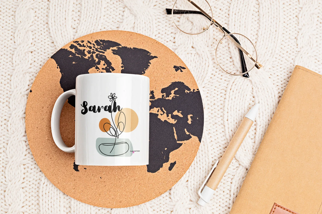 White ceramic mug with personalized Sarah name and floral swirl bowl graphic on front.