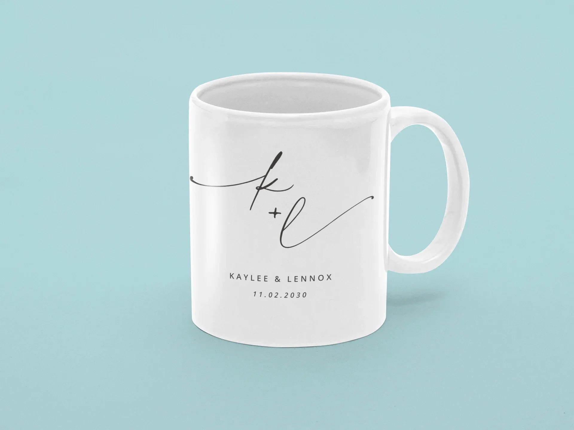 White ceramic mug with monogram k + l and date 11.02.2030, printed on side.