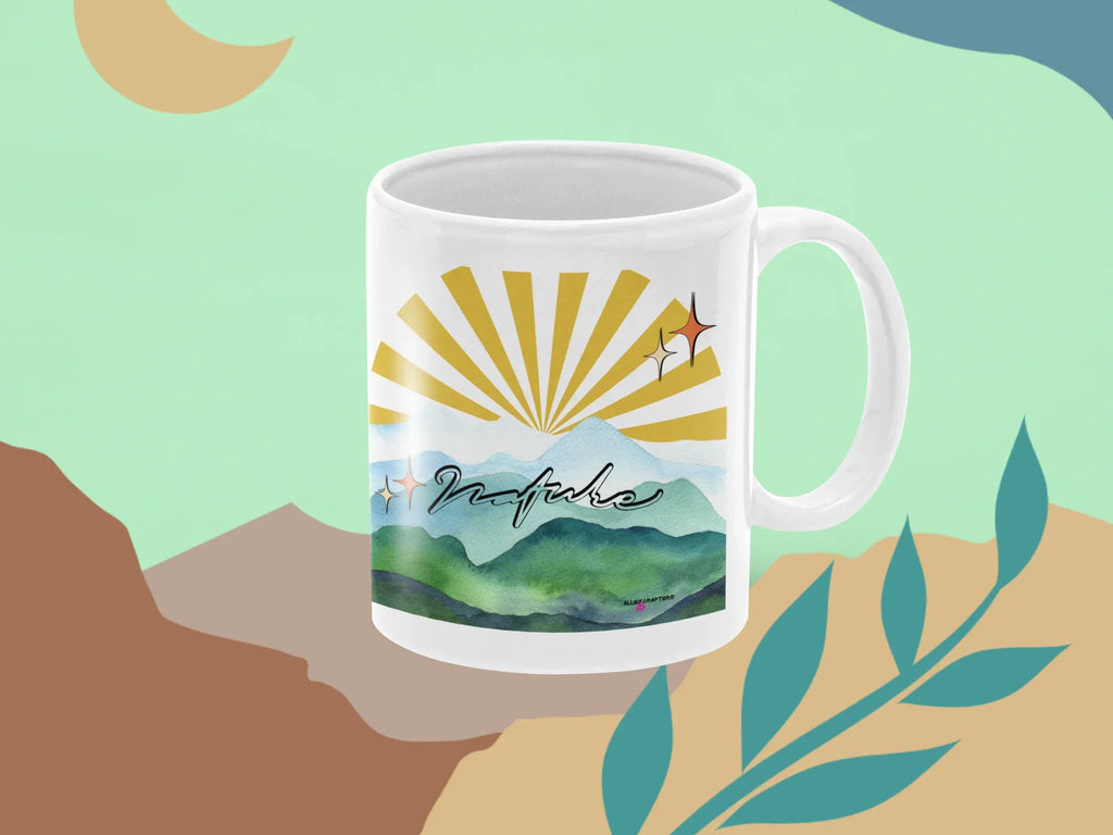 White coffee mug with sunrise rays and green mountain landscape print