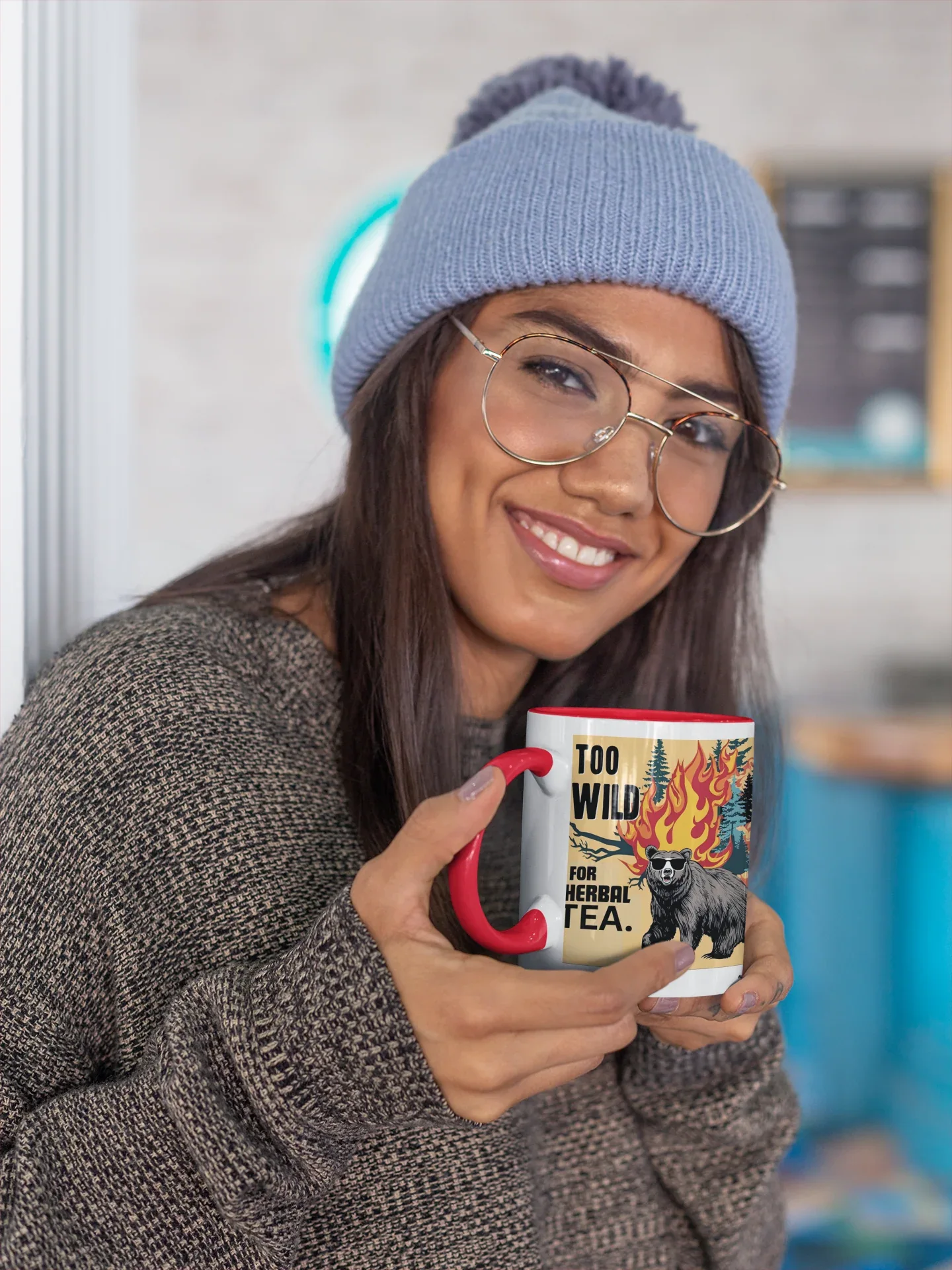 Ceramic tea mug with flaming cat graphic and red curved handle