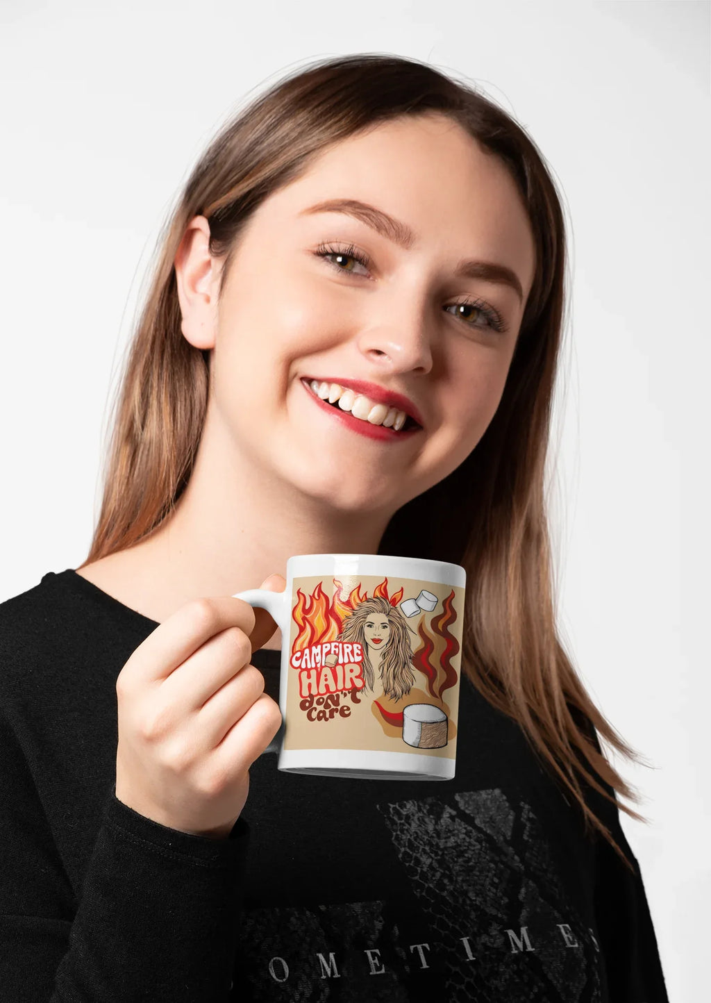 White ceramic mug with flame-haired woman and coffee cup graphic, held by smiling woman