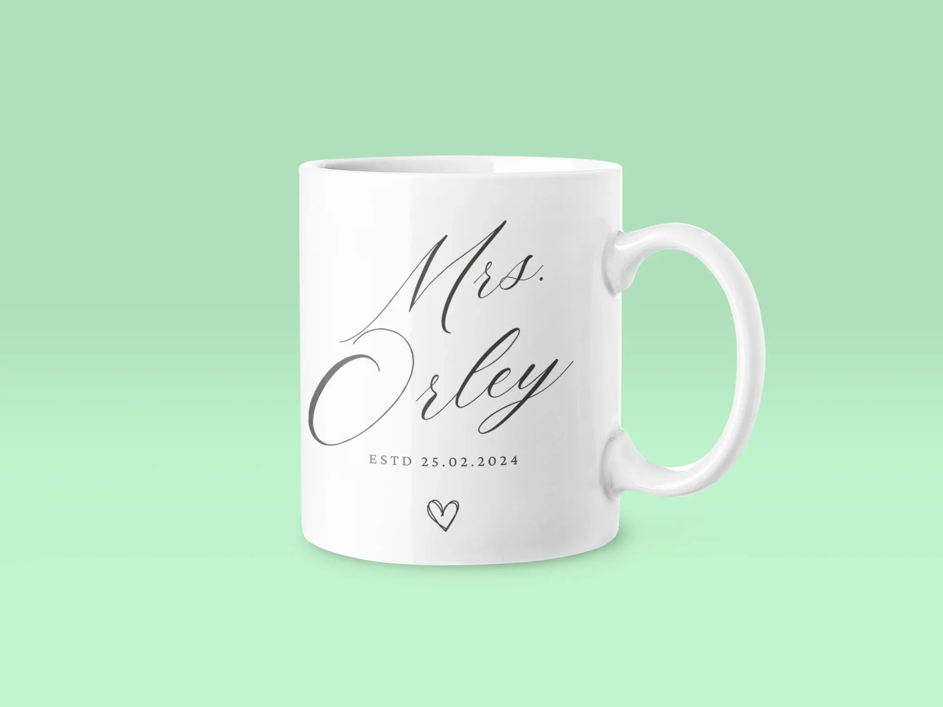 White ceramic mug with 'Mrs Orley' script, 'ESTD 25.02.2024' and small heart