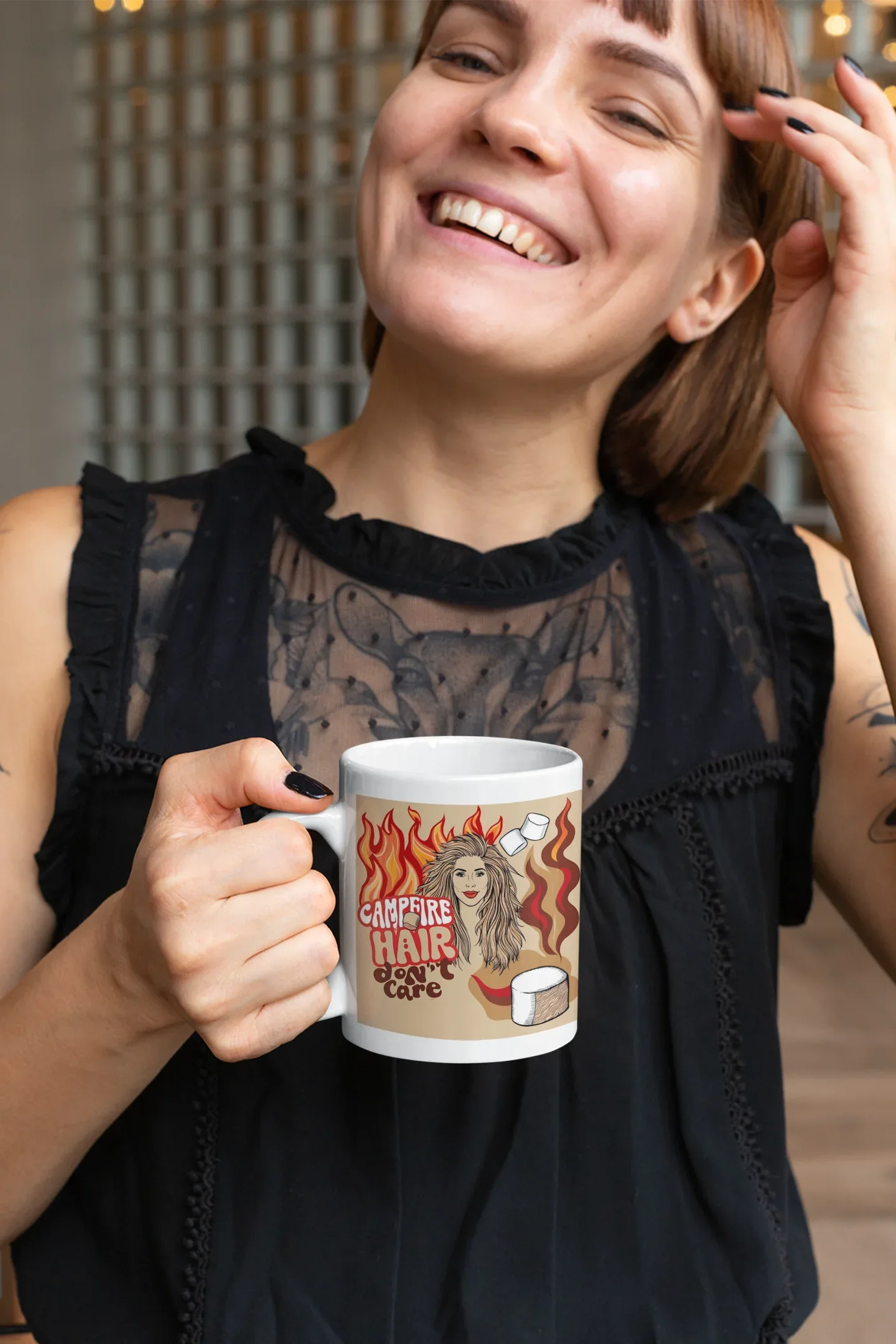 White ceramic mug with flame-haired woman and coffee cup graphic, held by smiling woman