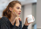 White ceramic teacher mug held up, 'teacher' text and quote on front