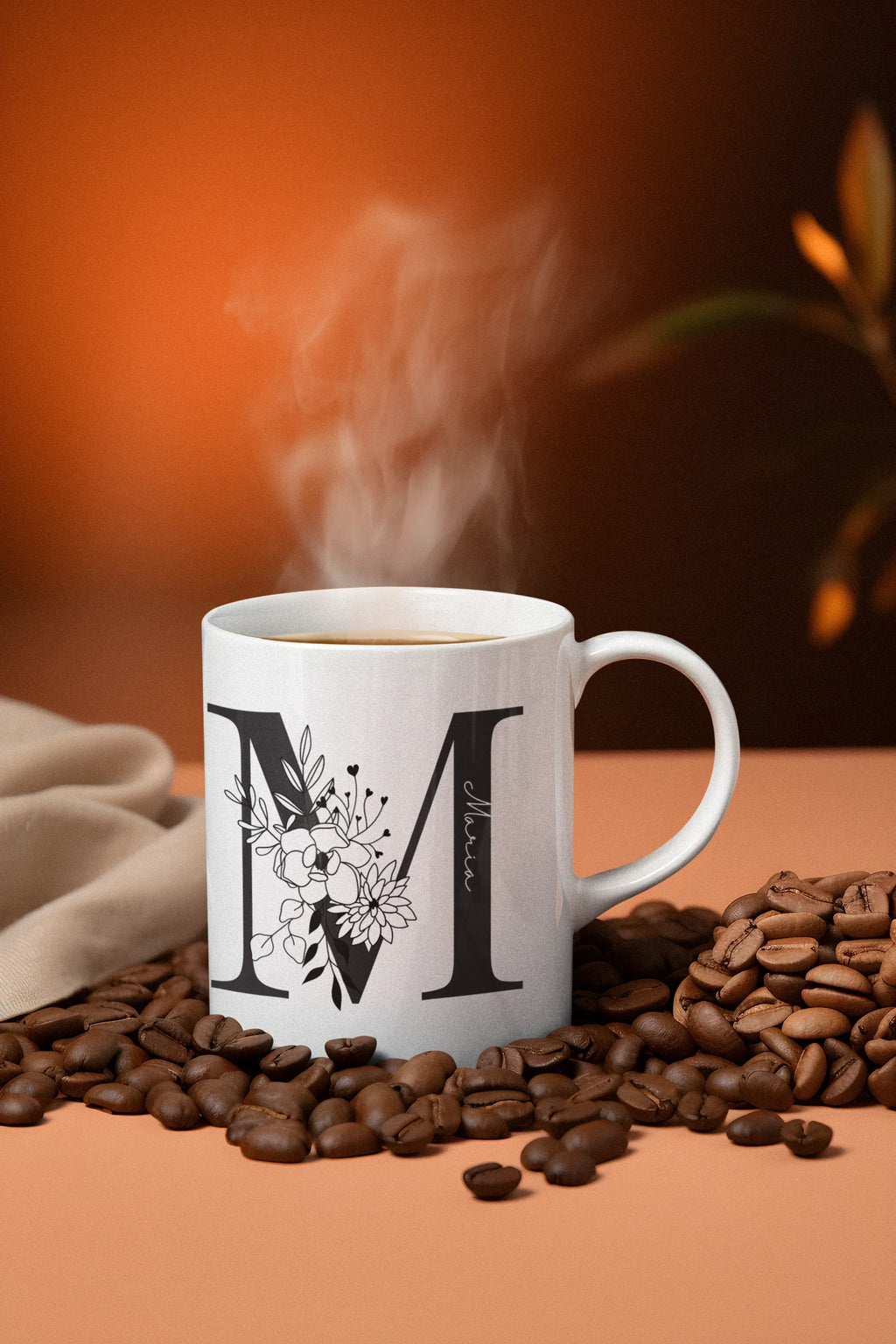 White mug with black letter I and floral line art, curved handle