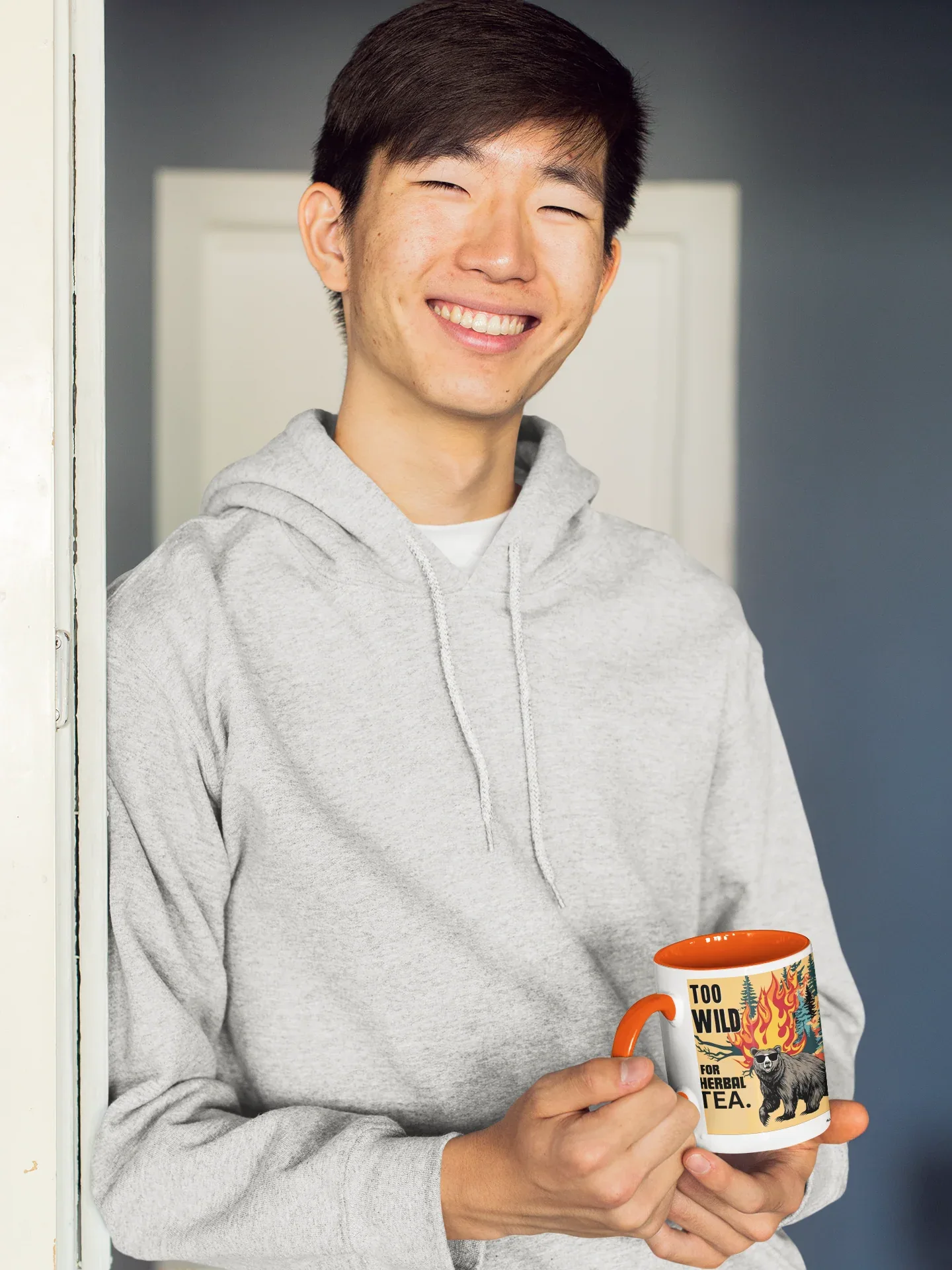 Printed ceramic tea mug with colorful flaming cat graphic and red handle