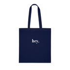 Dark navy cotton tote bag with custom text "hey."