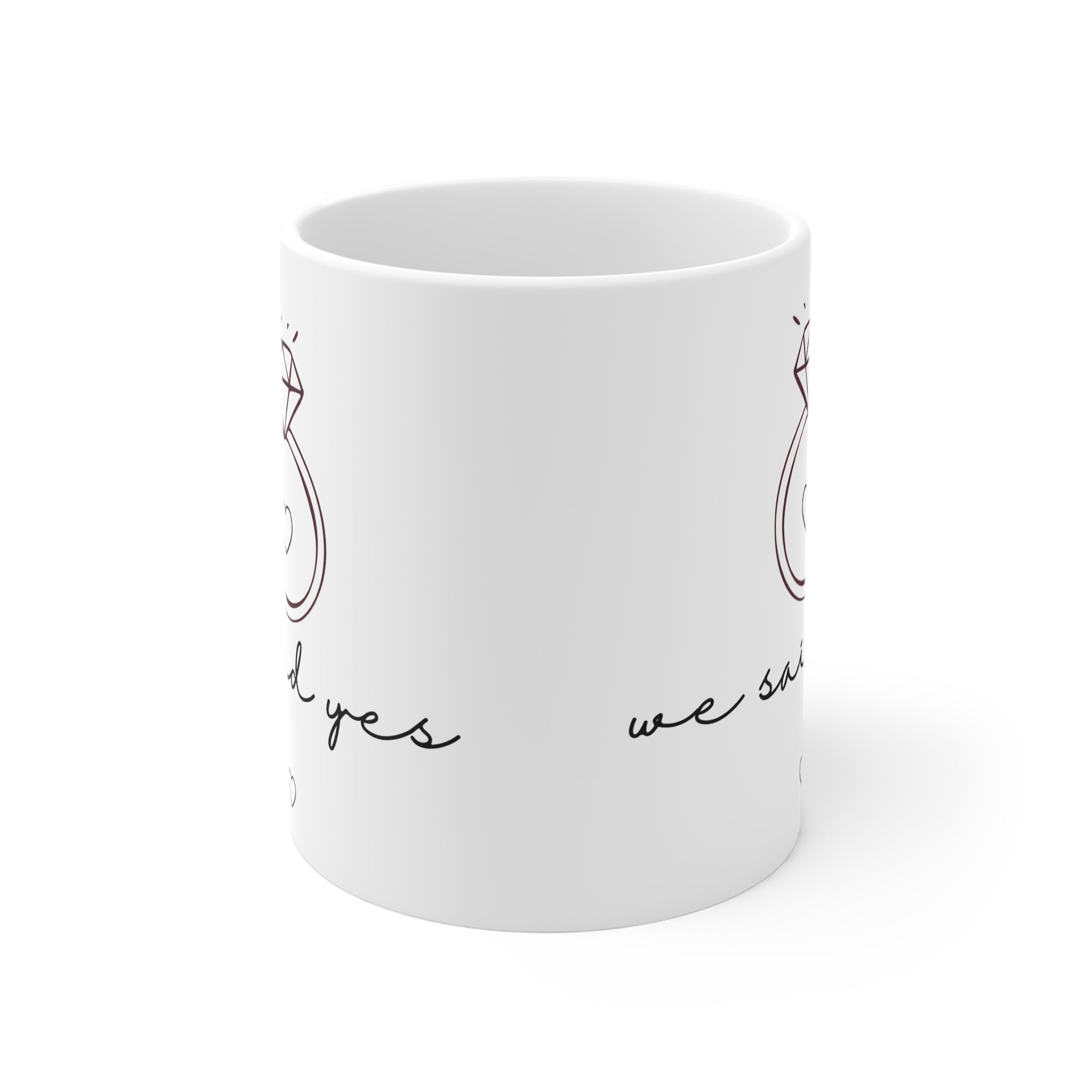 White coffee mug with partial diamond ring and "we said yes" printed on side