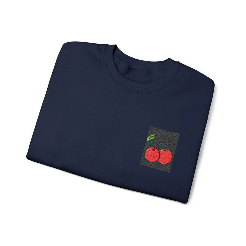 Navy sweatshirt folded flat with cherry embroidery patch on the left chest