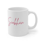 White ceramic mug with pink cursive name Siophan printed on the front.