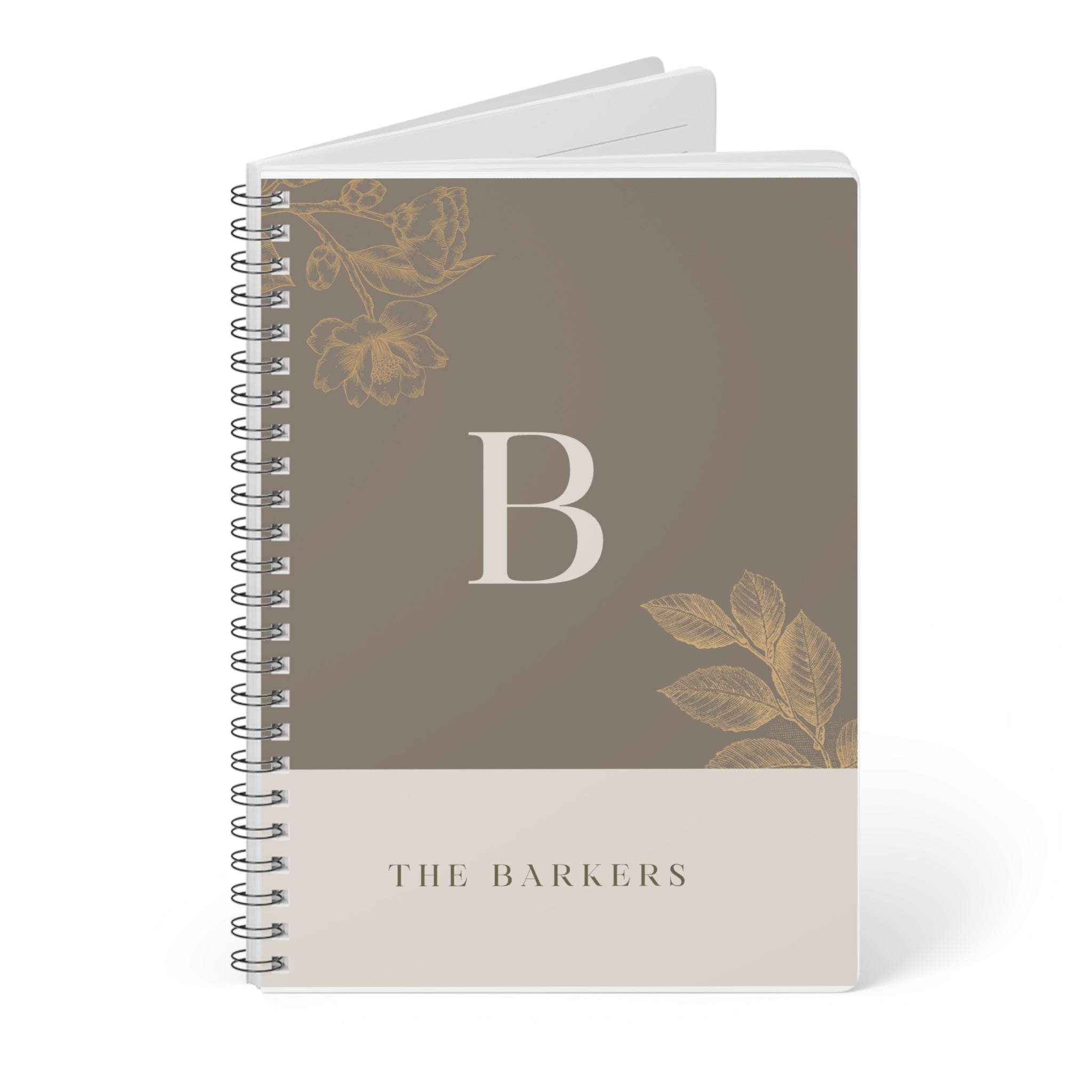 A5 notebook with taupe cover, gold monogram B, floral motifs, and stacked spiral binding.