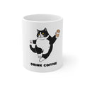 White 11oz coffee mug with black-and-white cat holding a cup and 'DRINK COFFEE'.