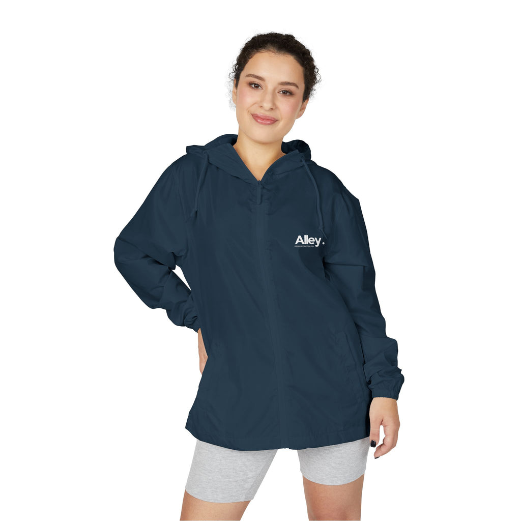 Lightweight hooded windbreaker jacket in dark blue, front zip and drawstring hood, worn by model.