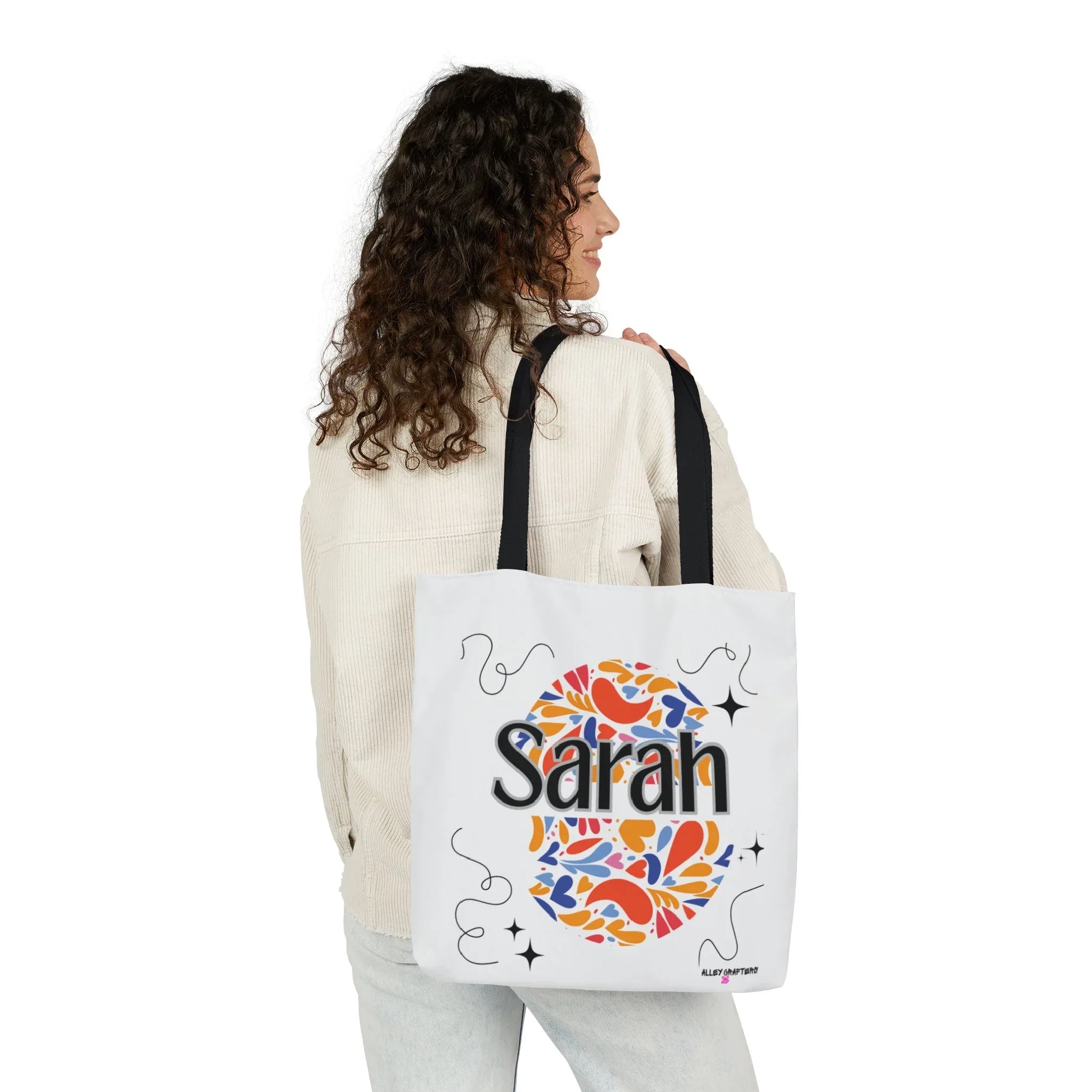 Personalized floral tote bag, white with black handles and “Sarah” heart graphic.