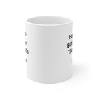 White coffee mug showing partial black text and a small star marking on the side