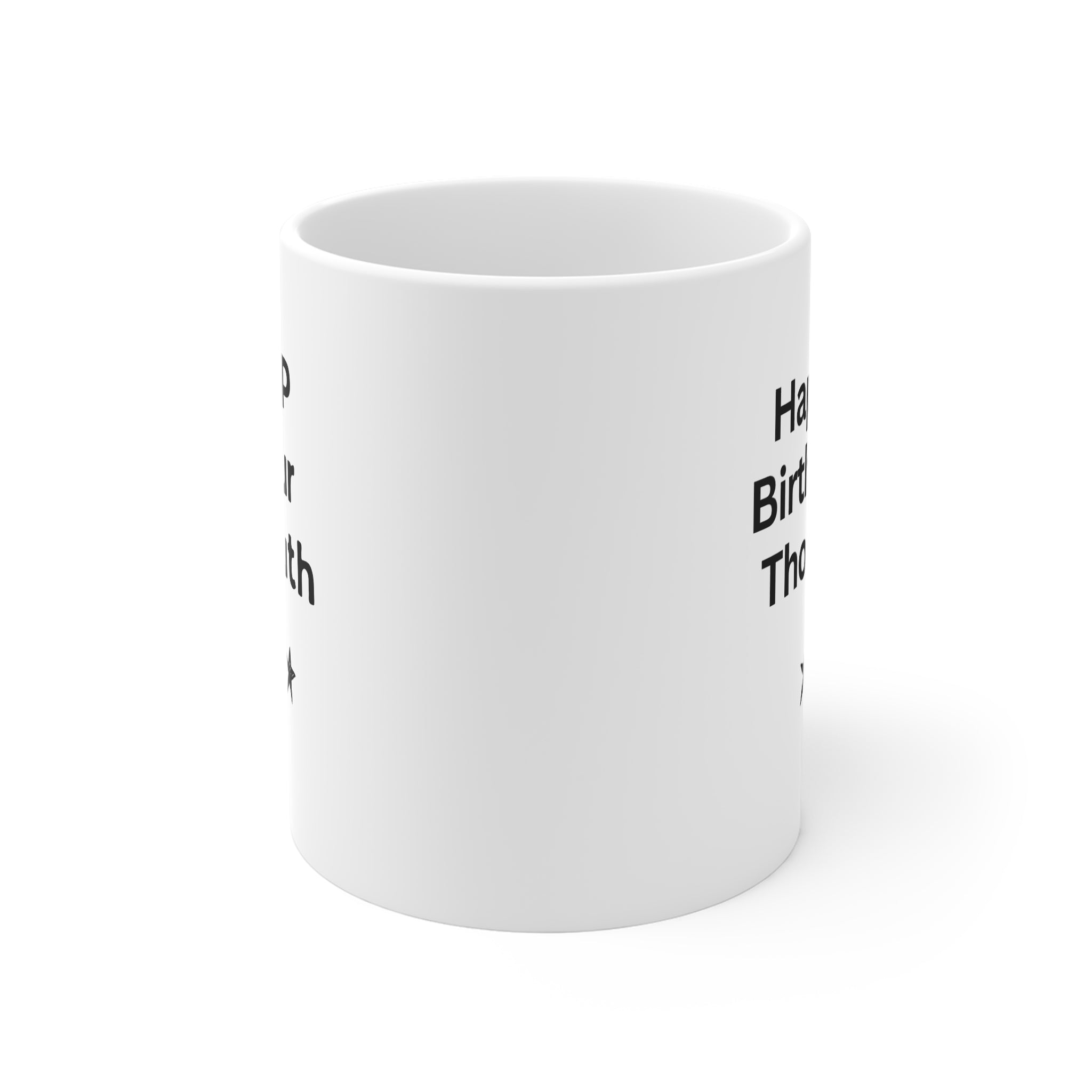 White coffee mug showing partial black text and a small star marking on the side