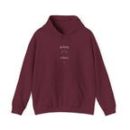 Maroon hoodie with “delulu vibes” graphic at chest, pullover style, front pocket.