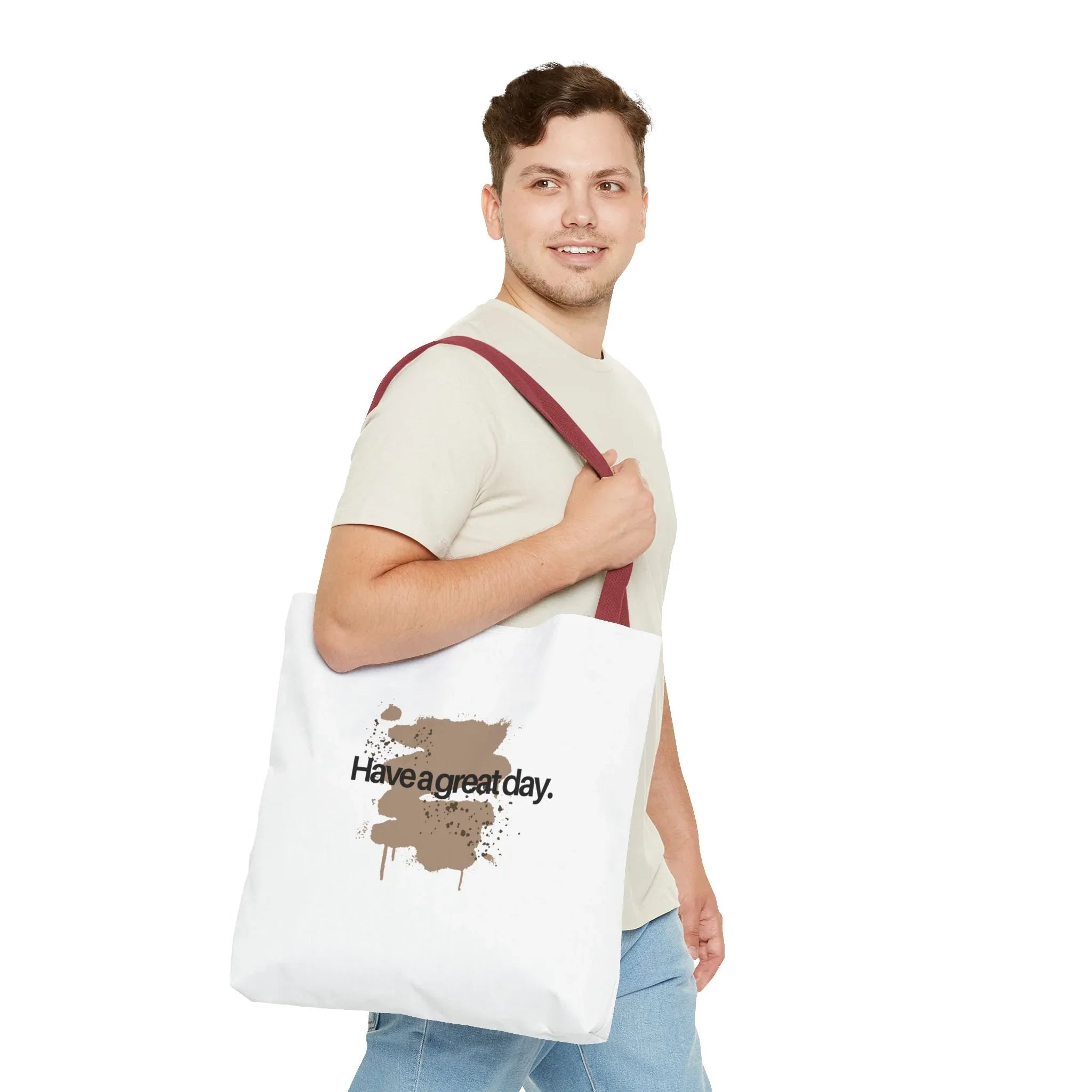 White canvas tote bag with red handles and brown splash “Haveagreatday.”
