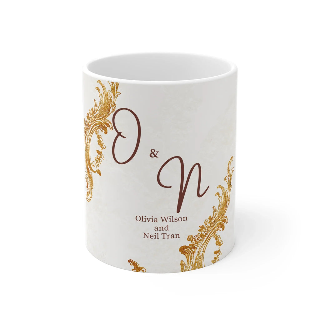 White ceramic mug with gold scrolls and dark red initials 'O & N' plus names