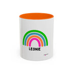 Personalised rainbow mug with LEONIE name, white body with orange rim and rainbow graphic