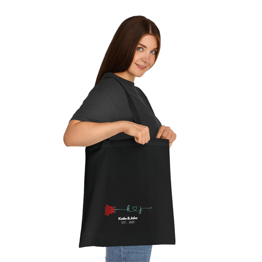 Black personalized rose tote bag with red rose print and 'Katie&Jake' text
