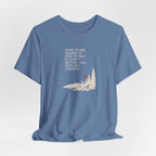 Lavender blue hiking T-shirt with woods scene graphic and quote text on front