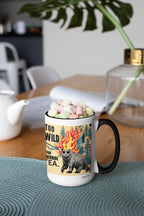 Navy ceramic mug with bear and fire flames graphic; reads “TOO WILD FOR HERBAL TEA.”