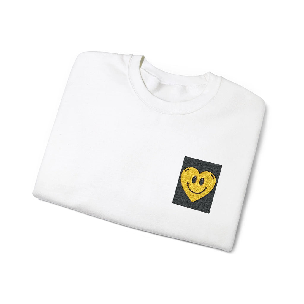 White crewneck sweatshirt with embroidered smiley heart patch on chest