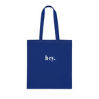 Royal blue cotton tote bag with custom text "hey."