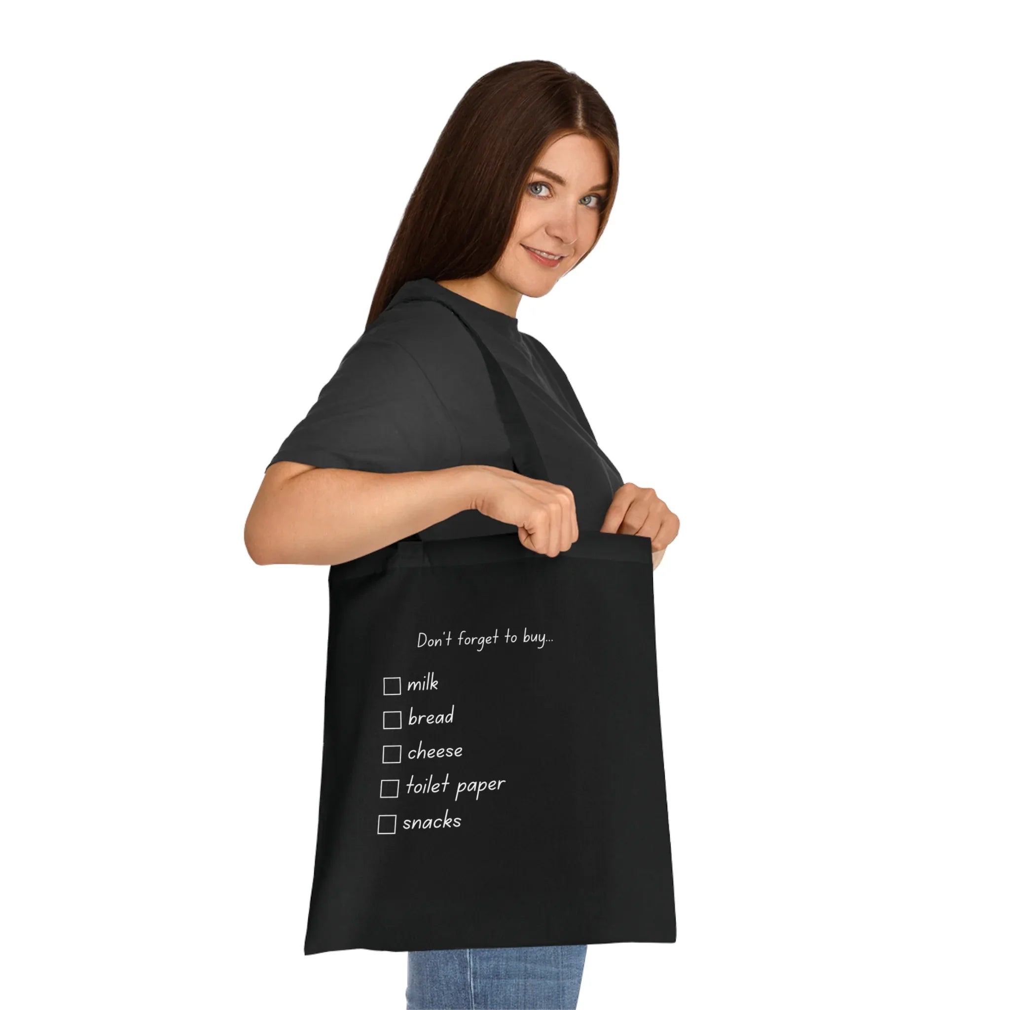 Black tote bag with 'Don't forget to buy' checklist: milk, bread, cheese, toilet paper, snacks.