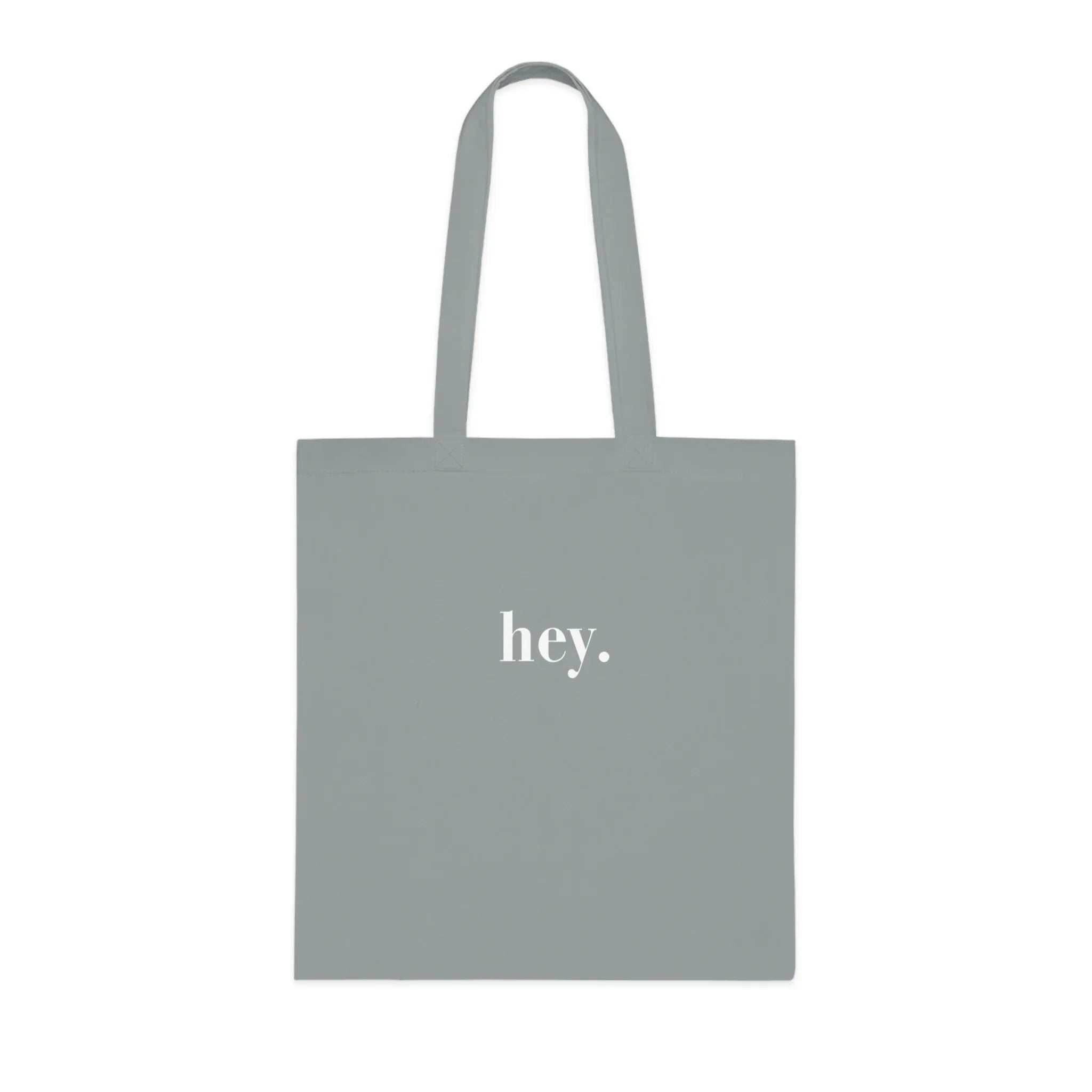Light gray cotton tote bag with custom text "hey."