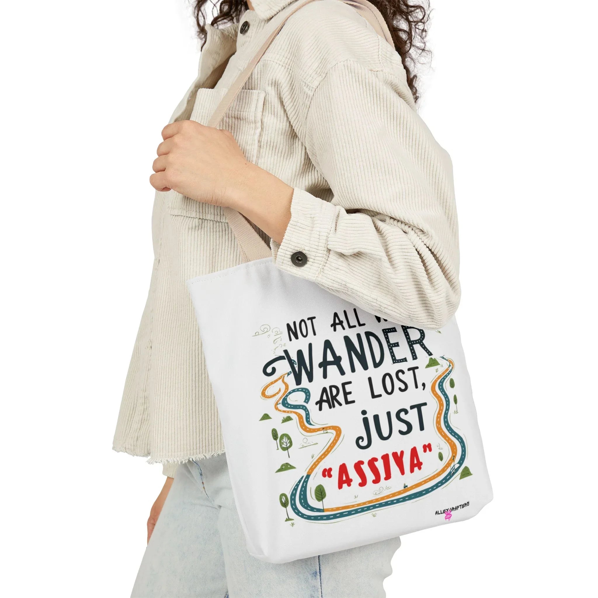 White tote bag with colorful quote print carried on the shoulder