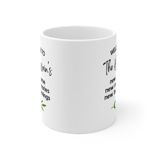 White mug with 'Welcome to The Hussains' text and green leaf sprig