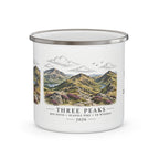 White enamel mug with Three Peaks landscape and "THREE PEAKS" text, silver rim