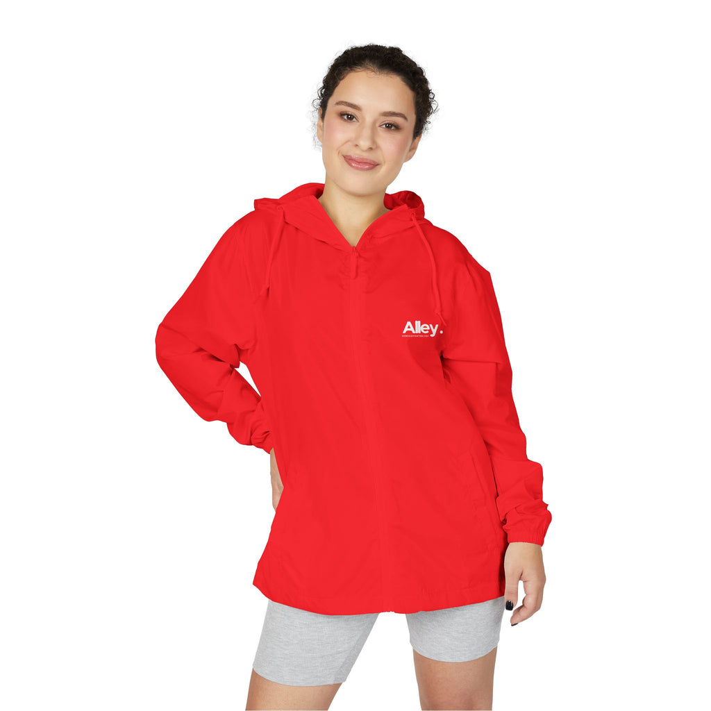 Lightweight hooded windbreaker jacket in red, front zip and drawstring hood, worn by model.