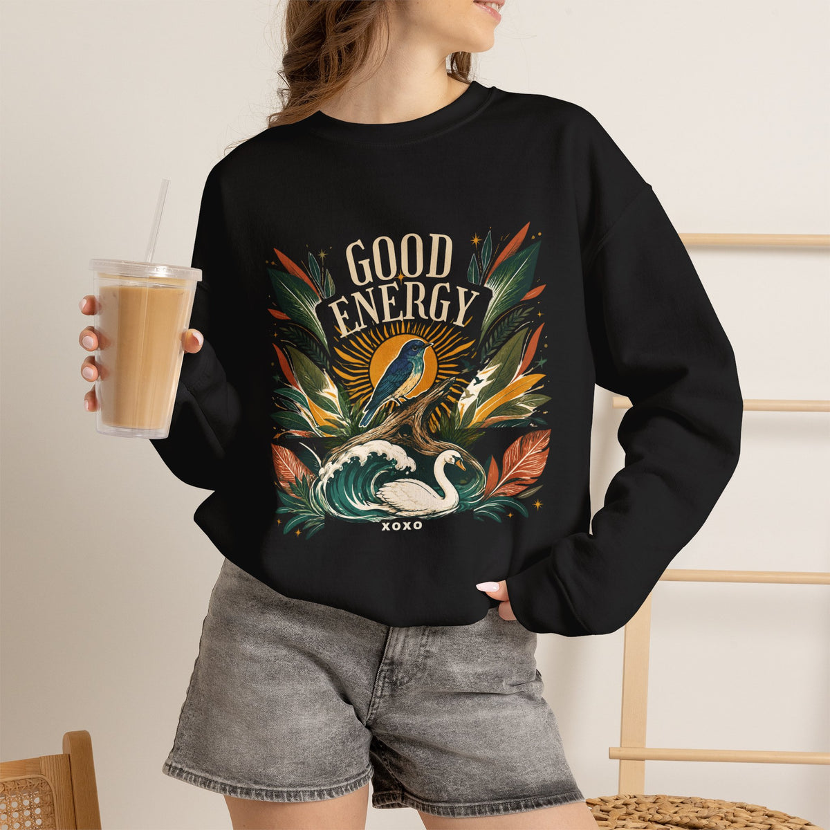 Black unisex sweatshirt with large botanical “Good Energy” front graphic