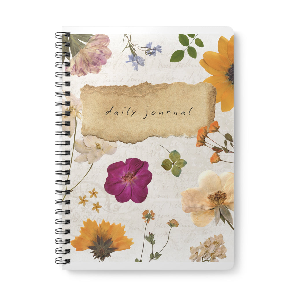 A5 floral wirebound notebook cover close-up, “daily journal” text over watercolor flowers