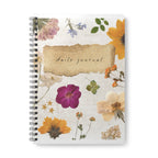 A5 floral wirebound notebook cover close-up, “daily journal” text over watercolor flowers