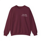 Maroon crewneck sweatshirt with a year wiser, a world kinder print