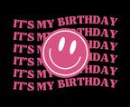 Pink 'It's my birthday' text with smiley face circle graphic on black hoodie